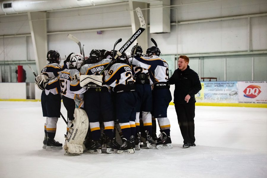 Last season, the hockey team won the eastern division. Above team members congratulate their goalie with assistant coach Seth Queen against North Hills Indians.