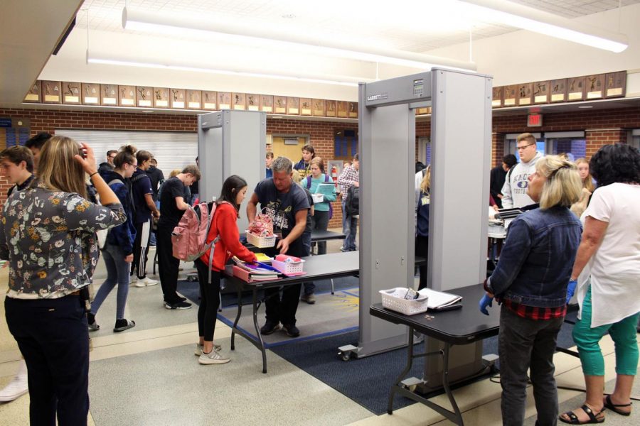 Students try not to drop their things as they shuffle through the newest technological advancement of KHS: metal detectors.