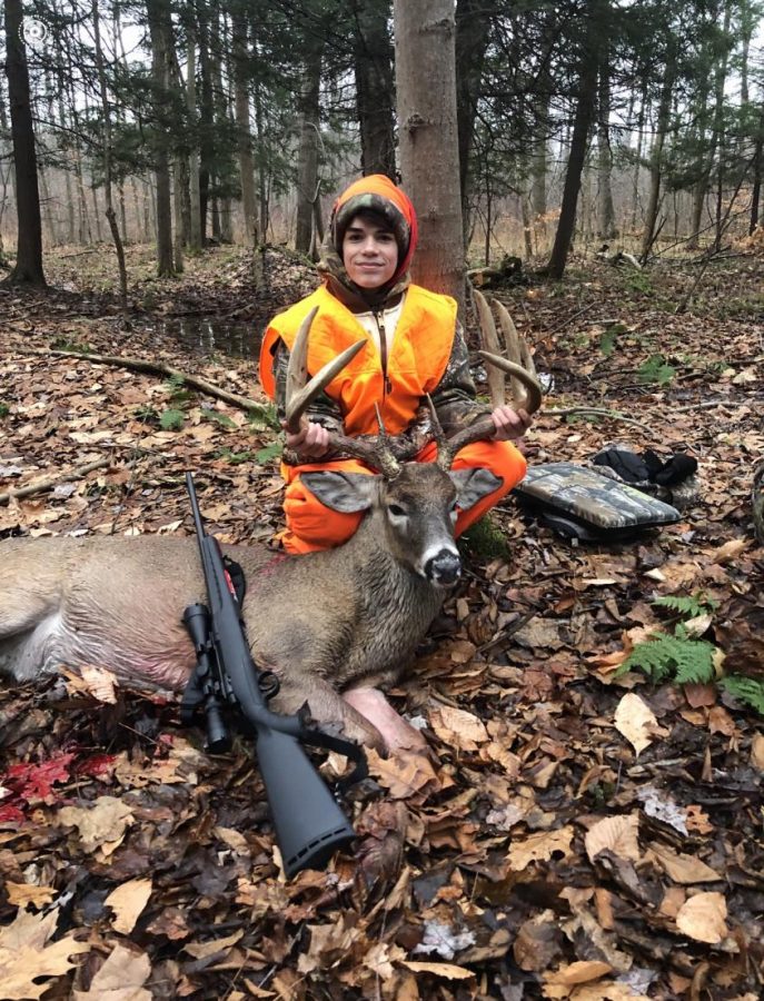 Mason Phillips poses with the ten point buck he shot in November. 